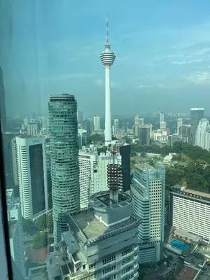 an aerial view of a city with a tower at KLCC vortex apartment suites Kuala Lumpur in Kuala Lumpur