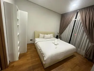 a bedroom with a white bed and a window at KLCC vortex apartment suites Kuala Lumpur in Kuala Lumpur