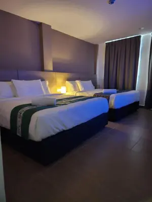 two beds in a hotel room with two at Yu Hotel Chinatown in Kuala Lumpur