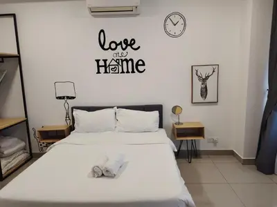 a bedroom with a bed with two slippers on it at Arte plus by Nicestay in Kuala Lumpur