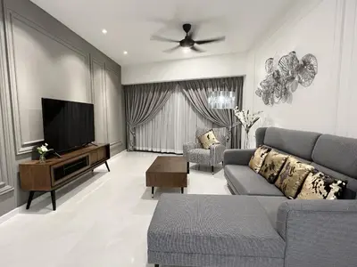 a living room with a couch and a flat screen tv at The Eaton Residences by Times 8 in Kuala Lumpur