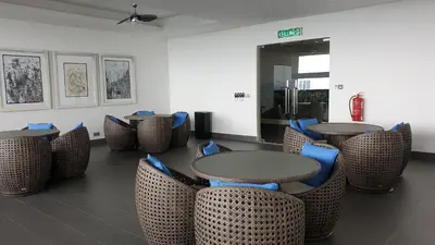 a dining room with tables and chairs with blue seats at M-City Ampang in Kuala Lumpur