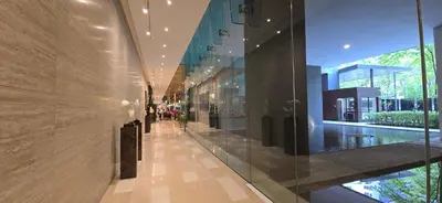a hallway in a building with glass walls at M-City Ampang in Kuala Lumpur
