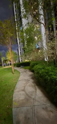 a path in a park next to a building at M-City Ampang in Kuala Lumpur