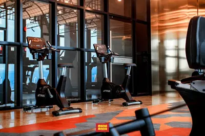 a gym with treadmills and ellipticals in a building at Scarletz Mana-Mana Suites KLCC in Kuala Lumpur