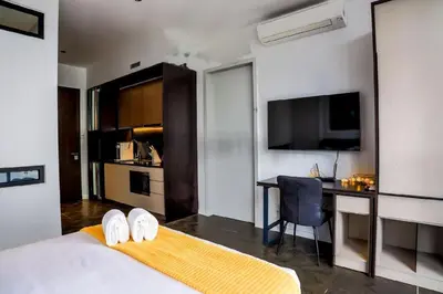 a hotel room with a bed and a desk with a computer at Scarletz Mana-Mana Suites KLCC in Kuala Lumpur