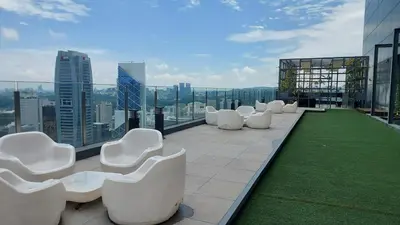 a group of white chairs sitting on top of a building at Anggun Presidential Suites in Kuala Lumpur