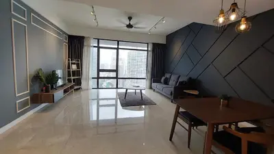a living room with a couch and a table at Anggun Presidential Suites in Kuala Lumpur