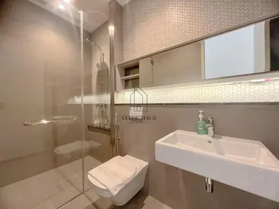 a bathroom with a sink and a glass shower at Lucentia Residences BBCC at Lalaport Kuala Lumpur by Veedu Hauz in Kuala Lumpur