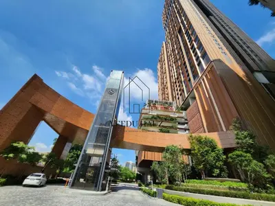 a tall building with a glass staircase in front of it at Lucentia Residences BBCC at Lalaport Kuala Lumpur by Veedu Hauz in Kuala Lumpur