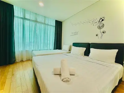 a hotel room with two beds with towels on them at VortexLuxApartman KLCC, kuala lampur city in Kuala Lumpur
