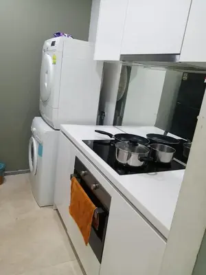 a kitchen with a stove with pots and pans on it at VortexLuxApartman KLCC, kuala lampur city in Kuala Lumpur