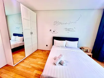 a small room with a bed and a mirror at VortexLuxApartman KLCC, kuala lampur city in Kuala Lumpur