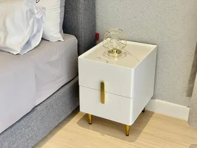 a white night stand next to a bed at Continew Residence by Shuen in Kuala Lumpur