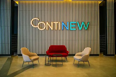 a conference room with two chairs and a red chair at Continew Residence by Shuen in Kuala Lumpur