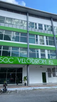a motorcycle parked in front of a building at SCC Velodrome KL in Kuala Lumpur