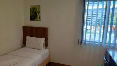 a small room with a bed and a window at SCC Velodrome KL in Kuala Lumpur
