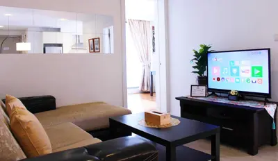 a living room with a couch and a flat screen tv at D'CASA Fairlane 