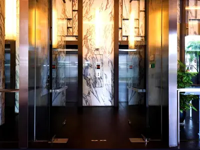 a row of elevators in a building with a door at D'CASA Fairlane 