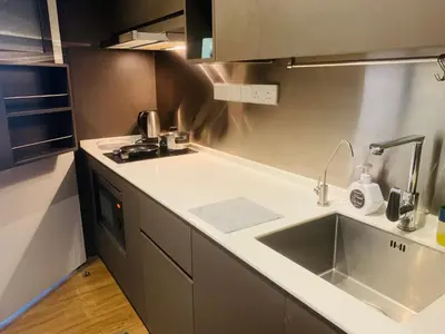 a kitchen with a sink and a counter top at Ceylonz Suites by ROOMY in Kuala Lumpur