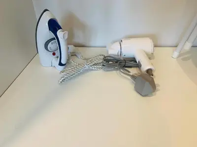 a hair dryer is tied to a wall at Ceylonz Suites by ROOMY in Kuala Lumpur