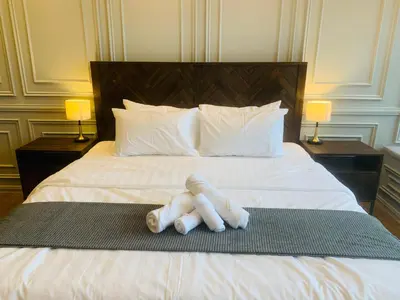 a stuffed animal is laying on a bed at Ceylonz Suites by ROOMY in Kuala Lumpur