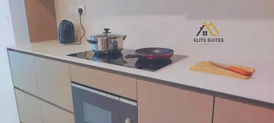 a kitchen counter with a stove with a pot on it at Eaton KLCC Suites By Elite in Kuala Lumpur