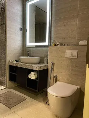a bathroom with a toilet and a sink and a mirror at STAR RESIDENCE KLCC in Kuala Lumpur