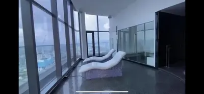 a balcony with two white chairs in a building at STAR RESIDENCE KLCC in Kuala Lumpur