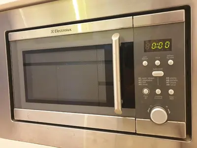 a microwave oven with a clock on it at The Signature & Hotel Suites Mont Kiara Kuala Lumpur in Kuala Lumpur