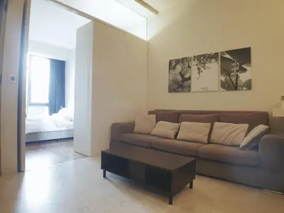 a living room with a couch and a coffee table at The Signature & Hotel Suites Mont Kiara Kuala Lumpur in Kuala Lumpur