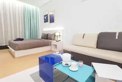 a living room with a couch and a bed at The Blueprint @ Bangsar South Mid Valley in Kuala Lumpur