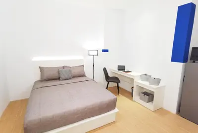a small bedroom with a bed and a desk at The Blueprint @ Bangsar South Mid Valley in Kuala Lumpur