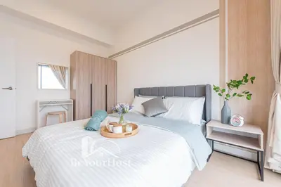 a bedroom with a bed with a table on it at Continew Residences Kuala Lumpur in Kuala Lumpur
