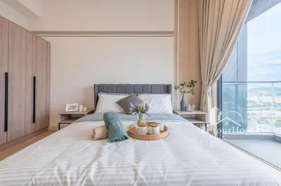 a bedroom with a large bed with a large window at Continew Residences Kuala Lumpur in Kuala Lumpur