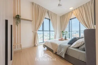 a bedroom with a bed and large windows at Continew Residences Kuala Lumpur in Kuala Lumpur