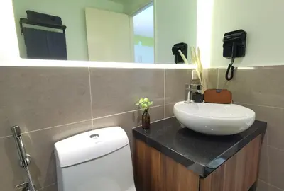 a bathroom with a sink and a toilet and a mirror at The Territory @ Bangsar South Mid Valley in Kuala Lumpur
