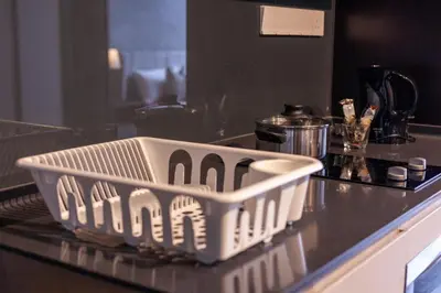 a dish basket sitting on top of a kitchen counter at Scarletz Suites KLCC in Kuala Lumpur