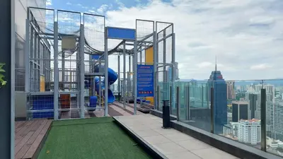 a balcony on top of a building with a playground at Anggun Platinum Suites in Kuala Lumpur