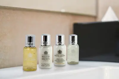 three bottles of essential oils sitting on a table at Banyan Signatures Pavilion Kuala Lumpur in Kuala Lumpur