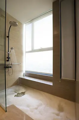 a bathroom with a shower and a large window at ExpressionZ Suites KLCC by EC in Kuala Lumpur