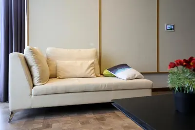 a white couch with a pillow on it in a living room at ExpressionZ Suites KLCC by EC in Kuala Lumpur