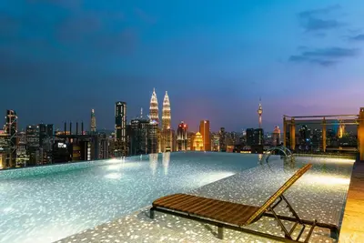 a swimming pool on top of a building with a city at ExpressionZ Suites KLCC by EC in Kuala Lumpur