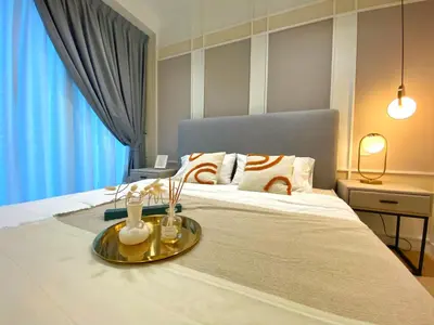 a bedroom with a large bed with a tray on it at Lily and Loft - Camellia @ Bangsar Kuala Lumpur in Kuala Lumpur