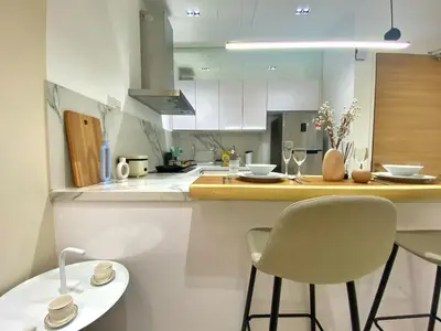 a kitchen with a counter and two chairs in it at Lily and Loft - Camellia @ Bangsar Kuala Lumpur in Kuala Lumpur