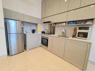 a kitchen with stainless steel appliances and white cabinets at Lucentia Residence World Class Facilities Apartment Infinity Pool Stunning View in Kuala Lumpur