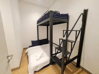 a room with a bunk bed and a ladder at Lucentia Residence World Class Facilities Apartment Infinity Pool Stunning View in Kuala Lumpur