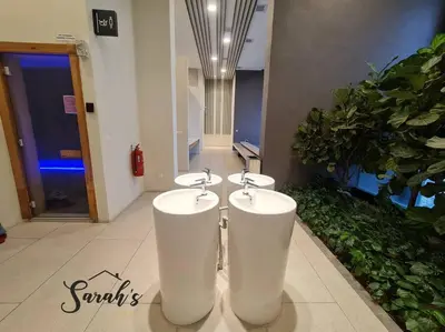 a bathroom with two sinks in a building at Lucentia Residence World Class Facilities Apartment Infinity Pool Stunning View in Kuala Lumpur