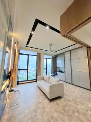 a living room with a white couch and large windows at Expressionz Professional Suites by AURORA SUMMER SUITES in Kuala Lumpur