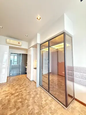 an empty room with glass doors and a wooden floor at Expressionz Professional Suites by AURORA SUMMER SUITES in Kuala Lumpur